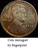 coin with fingerprint damage